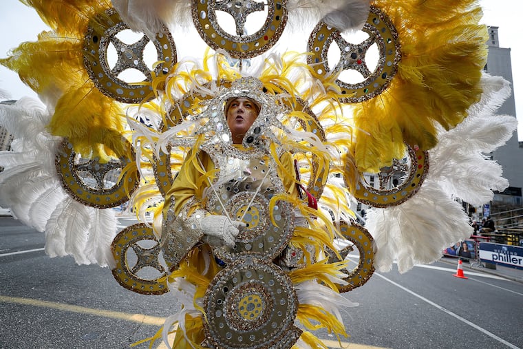 Jennifer Hensell, of Golden Sunrise, pauses near the judging area during the Mummers Parade in Philadelphia on Jan. 1, 2020.