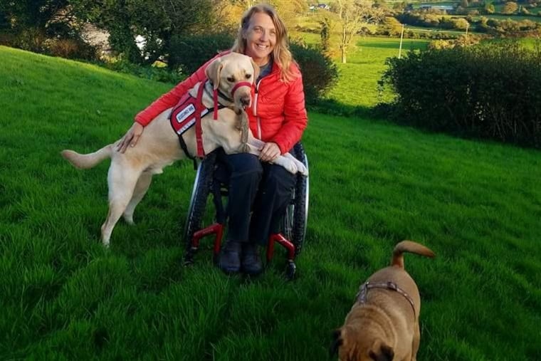 Chris Slavin of Danvers, Massachusetts, with her 3-year-old service dog, Earle, who is so well trained that he did not retaliate when attacked by a dog in a bogus service dog vest.