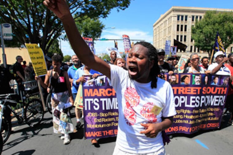 Demonstrators speak and move toward downtown during a protest march, Sunday, Sept. 2, 2012, in Charlotte, N.C. Demonstrators are protesting before the start of the Democratic National Convention. (AP Photo/Chuck Burton)