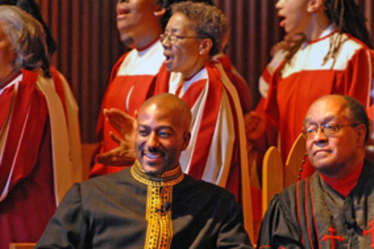Rev. Kevin Johnson (center), shown in February with Rev. William H. Gray III, plans a Jericho-like march to prevent the gentrification of a now-closed school.