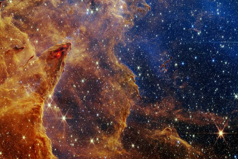 This image released by NASA on Wednesday, Oct. 19, 2022, shows the Pillars of Creation, captured by the James Webb Space Telescope in near-infrared-light view.