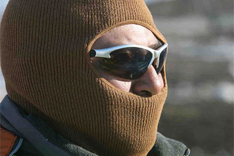 Jose Garcia is a spotter at Wilmington's Cherry Island Landfill. Spotters direct the trash vehicles as well as watch for things that may be improperly dumped: Asbestos, biowaste, bodies. (Charles Fox / Staff Photographer)