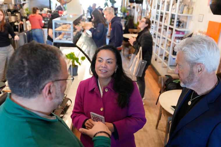 Analilia Mejia, the newly elected Democrat in New Jersey's 11th congressional district, talks to people at coffee shop in Morristown, N.J., Tuesday, March 24, 2026. (AP Photo/Seth Wenig)
