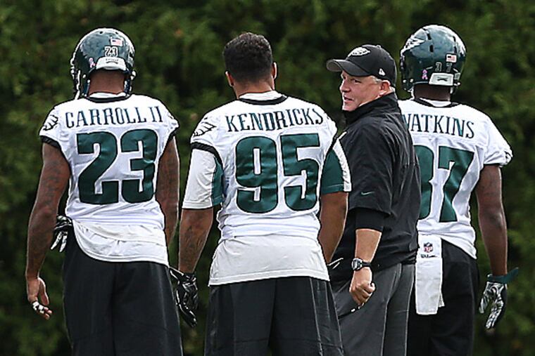 Eagles head coach Chip Kelly, linebacker Mychal Kendricks and cornerbacks Nolan Carroll and Jaylen Watkins. (David Maialetti/Staff Photographer)