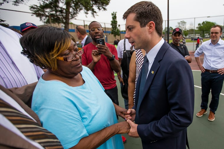In this Wednesday, June 19, 2019, photo, South Bend mayor and Democratic presidential candidate Pete Buttigieg talks with Shirley Newbill, mother of Eric Logan, during a gun violence memorial at the Martin Luther King Jr. Recreation Center in South Bend, Ind. (Michael Caterina / South Bend Tribune via AP)
