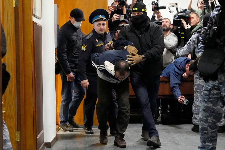 Saidakrami Murodali Rachabalizoda, a suspect in the Crocus City Hall shooting on Friday, is escorted by police and FSB officers in the Basmanny District Court in Moscow, Russia on Sunday, March 24, 2024.