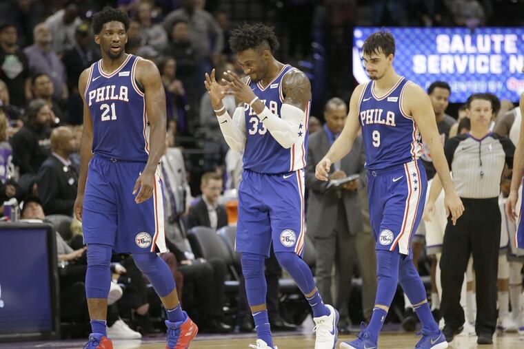 Philadelphia 76ers forward Robert Covington, center, reacts to a call as he walks off the court during a timeout with team members, Joel Embiid, of Cameroon, left, and Dario Saric, of Croatia, during the second half of an NBA basketball game against the Sacramento Kings, Thursday, Nov. 9, 2017, in Sacramento, Calif. The Kings won 109-108. (AP Photo/Rich Pedroncelli)