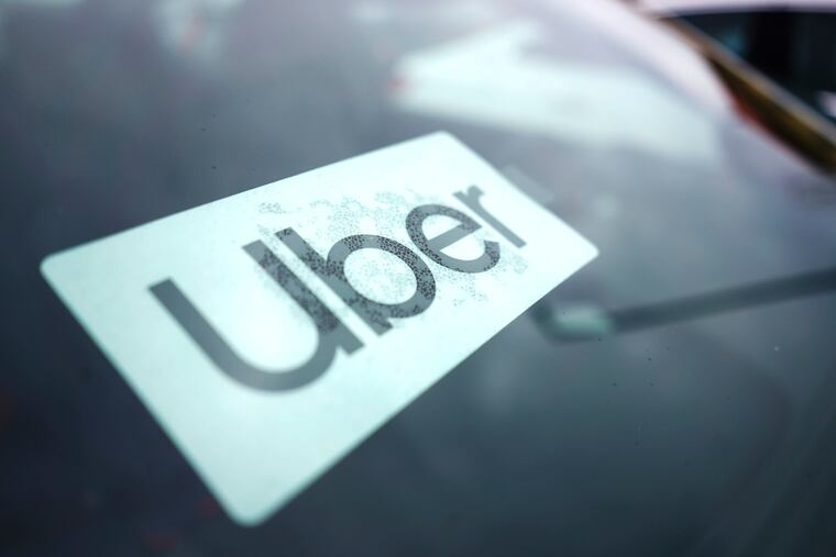 An Uber sign inside a car.