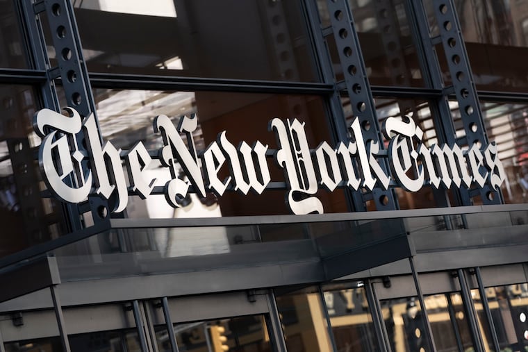 A sign for The New York Times hangs above the entrance to its building in 2021 in New York.