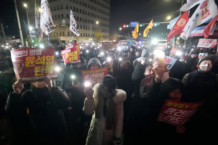People gather to demand South Korean President Yoon Suk Yeol to step down in front of the National Assembly in Seoul, South Korea, on Wednesday, Dec. 4, 2024.