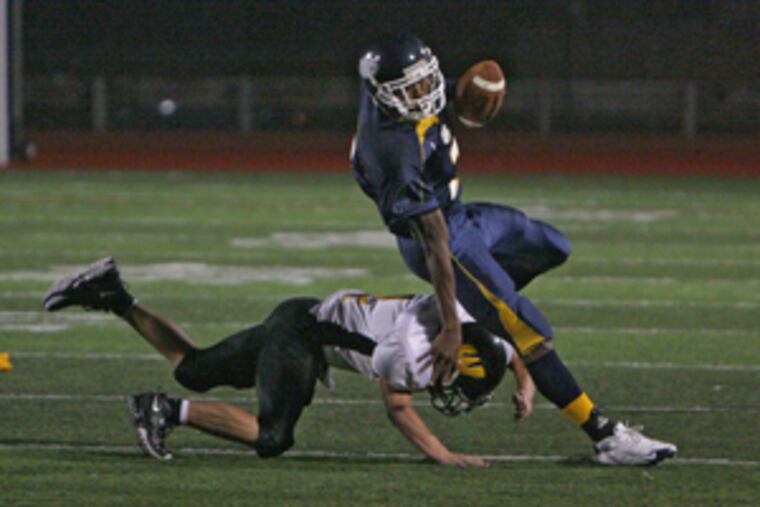 West Catholic running back Raymond Maples is taken down from behind by Archbishop Wood's Scott Adkins in a Sept. 26 game. West is favored in the District 1/12 Class AA subregional field.