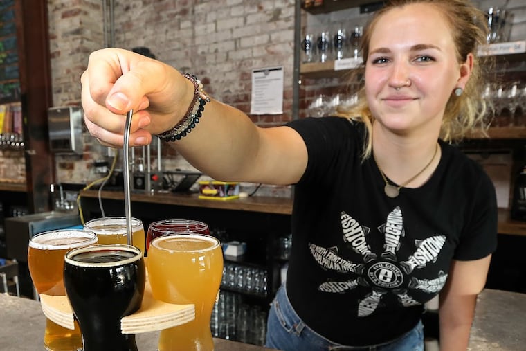 Back bartender Patti with a flight of beers at Evil Genius Beer Lab in Fishtown.