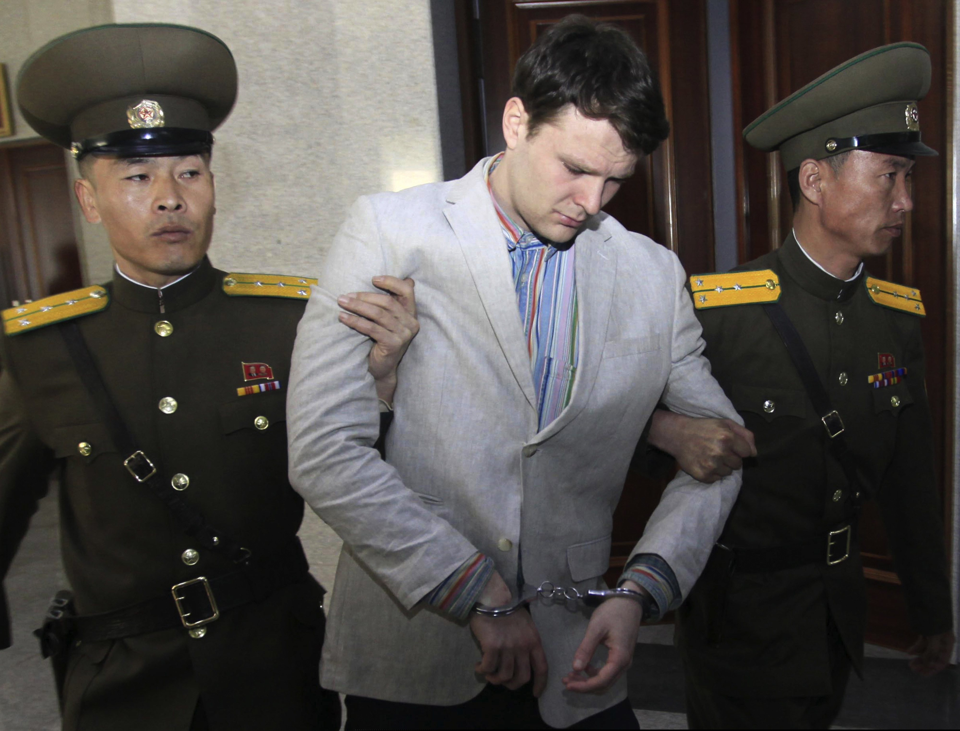 FILE - In this March 16, 2016, file photo, American student Otto Warmbier, center, is escorted at the Supreme Court in Pyongyang, North Korea. North Korea reportedly insisted the U.S. pay $2 million in medical costs in 2017 before it released Warmbier while he was in a coma.