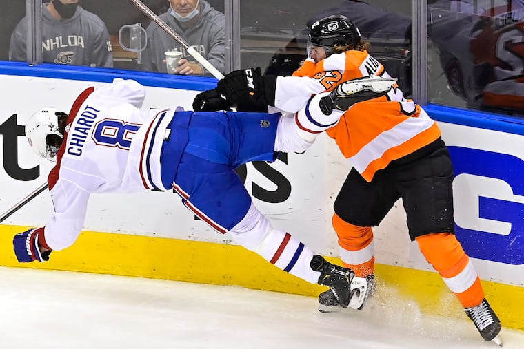 Nicolas Aube-Kubel sends Montreal's Ben Chiarot flying during the first period of Wednesday's game in Toronto.