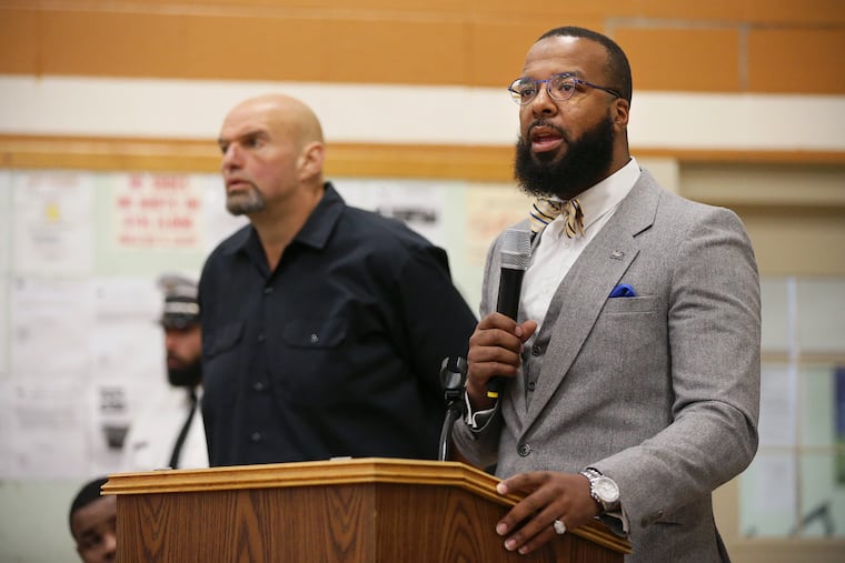Lt. Gov. John Fetterman (back) stands as Secretary of the Board of Pardons Brandon Flood talks about the commutation process at SCI Dallas in Dallas, Pa., on Thursday, Oct. 10, 2019.