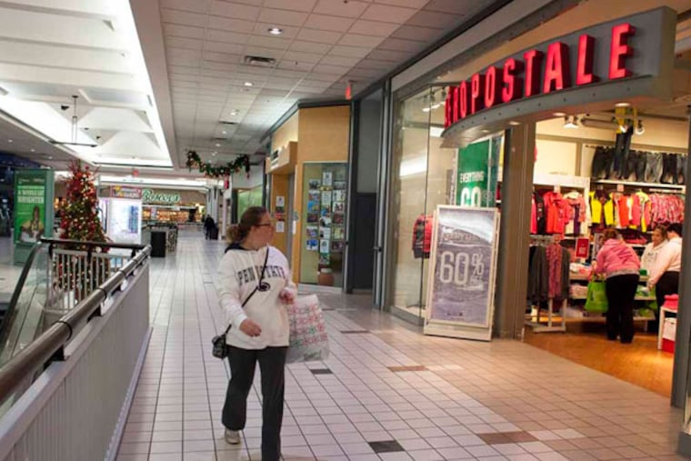 Black Friday shopper Christina Paytas, of Broomall walks past near empty shops in 2012 at the Granite Run Mall in Media Pa. (ED HILLE / Staff Photographer)