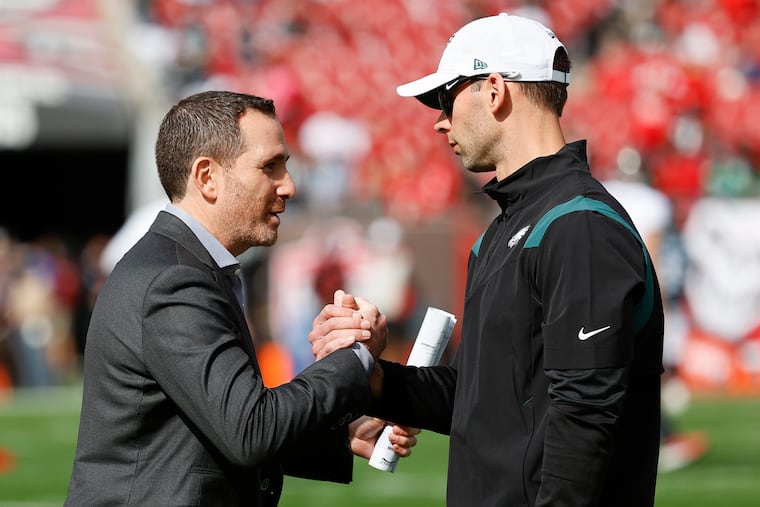 Eagles Executive Vice President/General Manager Howie Roseman shakes hands with defensive coordinator Jonathan Gannon before the Eagles played the Tampa Bay Buccaneers in a NFC Wildcard playoff game on Sunday in Tampa Bay.