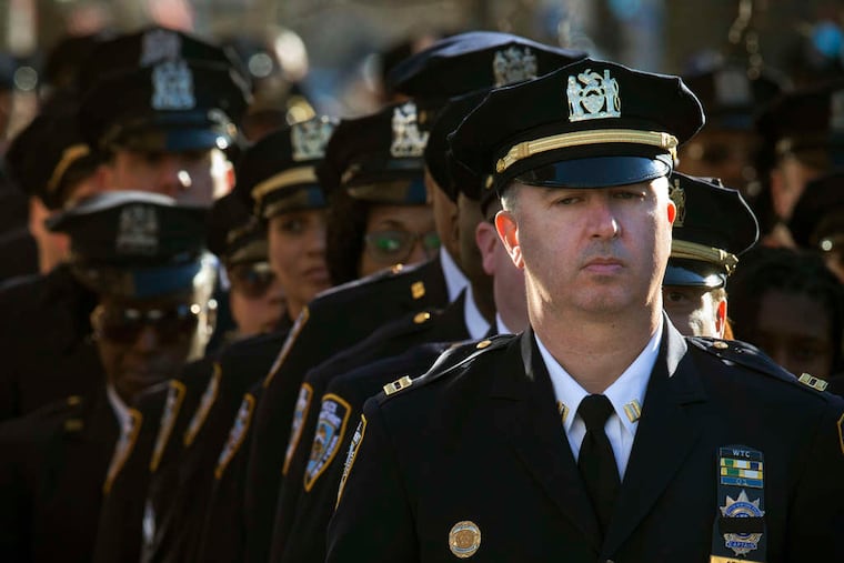JOHN MINCHILLO / ASSOCIATED PRESS NYPD officers wait to pay respects to Officer Rafael Ramos.