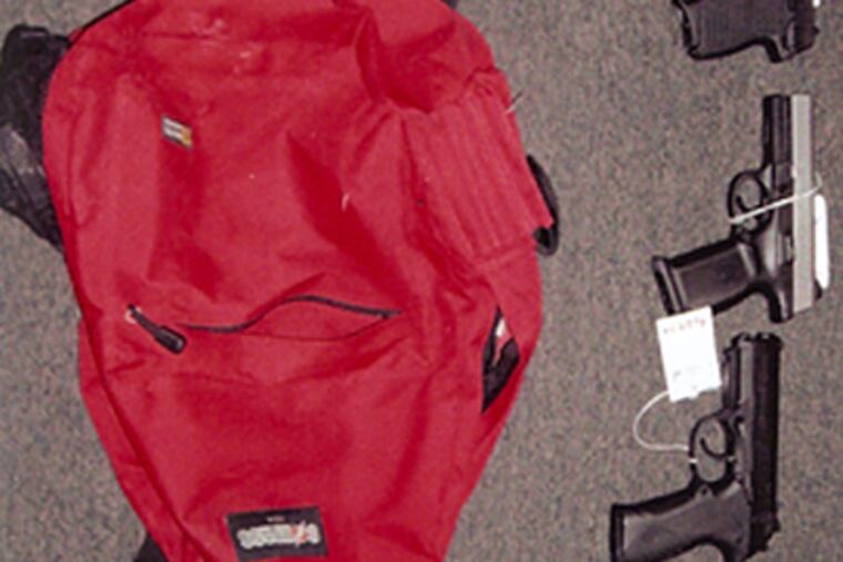 Handguns and school bag that authorities say were used in the heist of 15 weapons and ammo from Suburban Armory in Delaware County. (Collingdale Police Department)