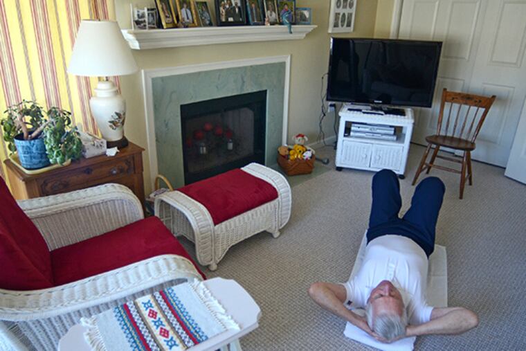 Bill Dougherty begins his attempt to do 1,000 stomach crunches January 5, 2015. He turned 90 on Jan 3, and the feat was his birthday goal. ( TOM GRALISH / Staff Photographer )