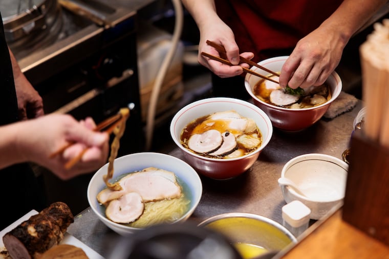 Chefs prepare bowls of ramen at Ramenya Toy Box in November in Tokyo, the capital of Japan. Pristine renditions of three classic styles won owner Takanori Yamagami induction into the ramen hall of fame in 2024.