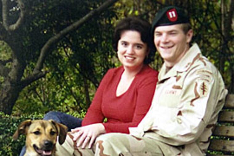 Army Capt. Charles Robinson, his wife, Laura, and their dog, Buster, in 2004. Charles Robinson, a graduate of Baptist Regional School in Haddonfield, was killed while serving in Afghanistan in June 2005.