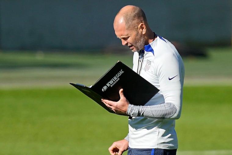 US head coach Gregg Berhalter reads a book during a training session of the US soccer team in Cologne, Germany, prior to a friendly match against Japan, Thursday, Sept. 22, 2022. The USA will play Japan in a friendly soccer match as part of the KIRIN CHALLENGE CUP to prepare for the World Cup in Qatar in Duesseldorf on Friday. (AP Photo/Martin Meissner)