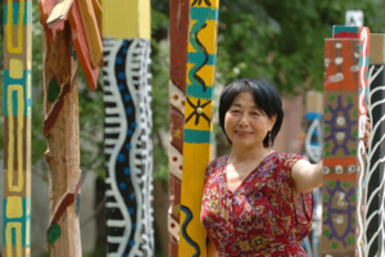 Artist and activist Lily Yeh with a local project in 2005, the year after she first started working to bring business and art to refugees in Rwanda. "I feel my calling is to bring beauty and joy to people in despair," Yeh says.