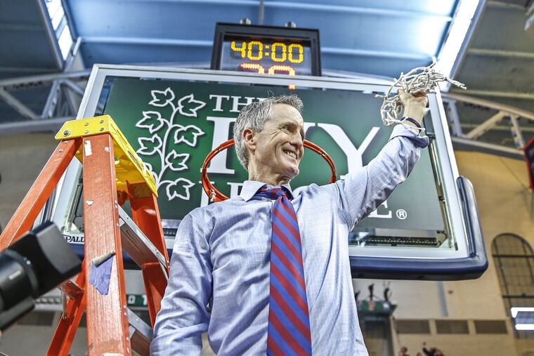 Steve Donahue raises the net after the Ivy League tournament final.