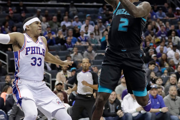 Charlotte Hornets' Marvin Williams (2) shoots against Philadelphia 76ers' Tobias Harris (33) during the first half of an NBA basketball game in Charlotte, N.C., Tuesday, March 19, 2019. (AP Photo/Chuck Burton)