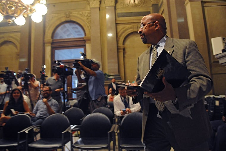 Mayor Michael Nutter walks into Conversation Hall in City Hall to speak about street closures and other security restrictions during Pope Francis' visit in September on July 27, 2015. ( CLEM MURRAY / Staff Photographer )