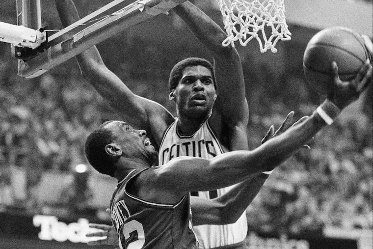 Philadelphia 76ers Andrew Toney slips by Boston Celtics Robert Parish for two of his 34 points in Game 7 of the 1982 Eastern Conference finals.