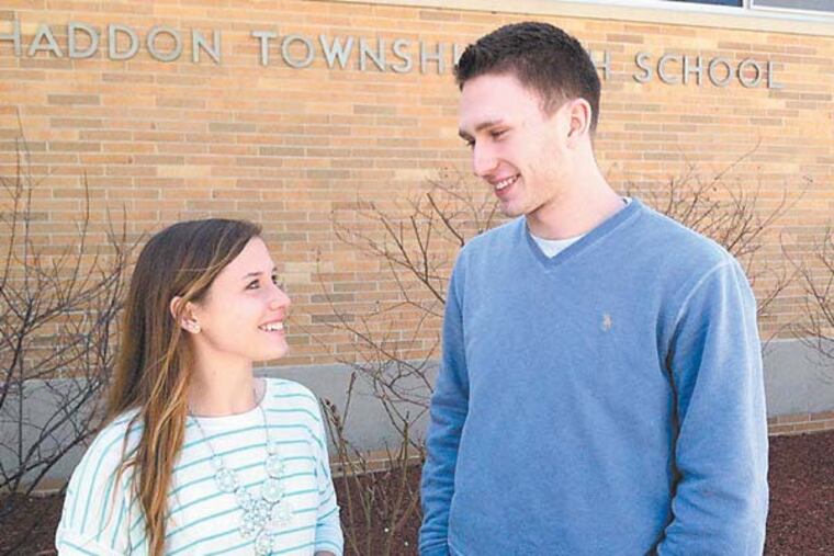 Haddon Township High School senior Kelly Nelson, left, was surprised when classmate and lifelong friend Patrick Burns asked her to the prom -- by building an 8-foot invitation out of plastic cups. (Photos by Kevin Riordan)