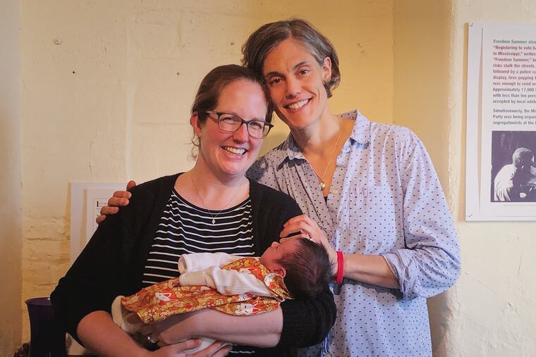 Kristen (left) and Becky Ashare with Maggie Maureen at her November baby naming ceremony at congregation Mishkan Shalom.