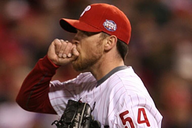 Brad Lidge blows on his hands after giving up the game-deciding double to Alex Rordriguez in the ninth ining. (Yong Kim/Staff photographer)