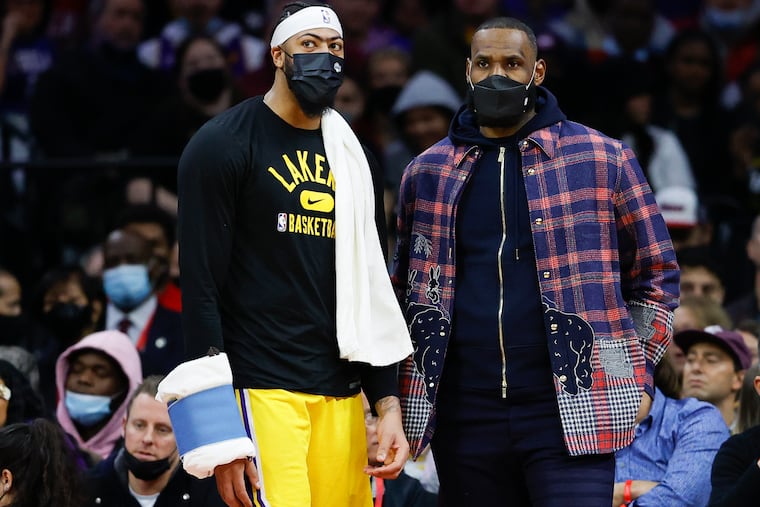 Los Angeles Lakers forward LeBron James and teammate forward Anthony Davis talk during a break against the Sixers in the third quarter on Thursday, January 27, 2022 in Philadelphia.