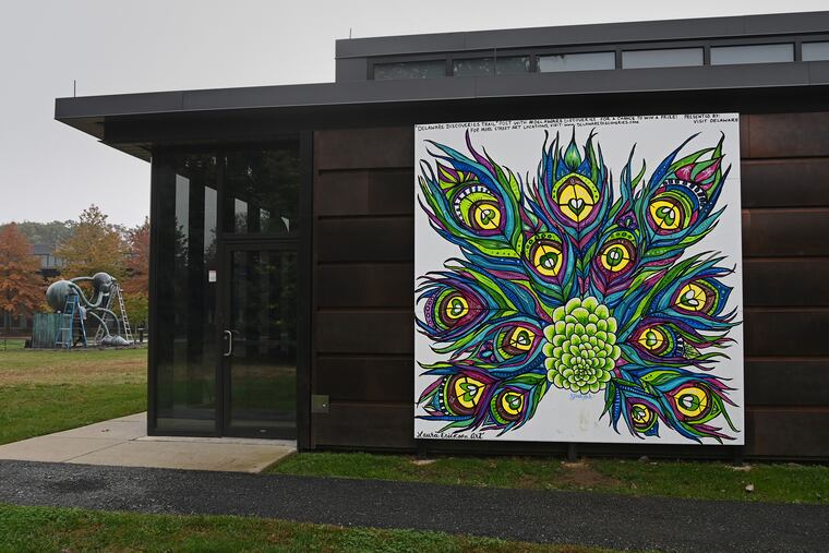 Laura Erickson's painting of peacock feathers adds a dash of color to the Copeland Sculpture Garden at the Delaware Art Museum in Wilmington. Over the past year, U.S. paint companies have been in chaos getting certain colors.