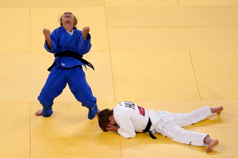 Odette Giuffrida, of Italy, left, reacts after defeating Reka Pupp, of Hungary, during a women's 52kg bronze medal judo match at the Tokyo 2020 Olympics, Sunday, July 25, 2021, in Tokyo. (AP Photo/David Goldman)