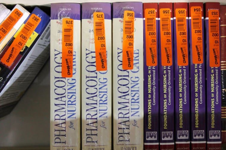 Textbooks sit on a shelf at the Chegg Inc. warehouse in Shepherdsville, Kentucky, U.S., on Thursday, April 29, 2010. No more $120 chemistry books. That's the message from textbook-rental service Chegg Inc., which is urging college students to stop paying top dollar to buy their tomes. (John Sommers II / Bloomberg)