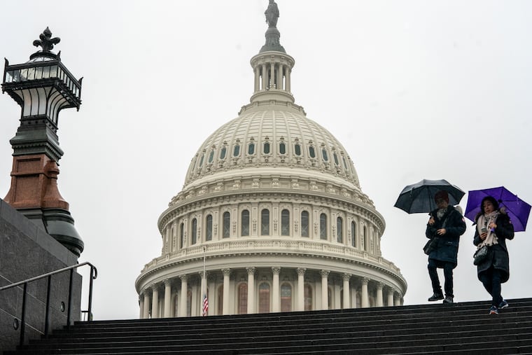 Tourists arrive to visit the U.S. Capitol on a rainy morning in Washington, Friday, Dec. 28, 2018, during a partial government shutdown. The partial government shutdown will almost certainly be handed off to a divided government to solve in the new year, as both parties traded blame Friday and President Donald Trump sought to raise the stakes in the weeklong impasse. (AP Photo/J. Scott Applewhite)
