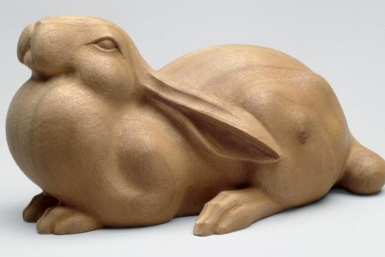 Ota Ryohei's "(Rabbit Gazing at the) Moon" in wood, about 1940. Many of the exhibition's forms and decorative schemes are inspired by animals, birds and flowers.