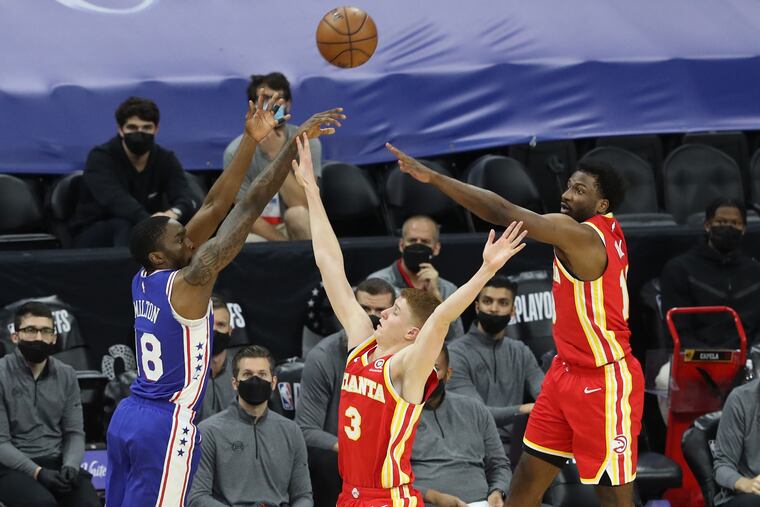 Shake Milton (left) hitting a three-pointer over Atlanta's Kevin Huerter in the third quarter Tuesday.