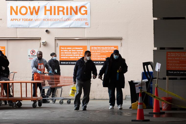 A sign at a Home Depot says it's hiring.