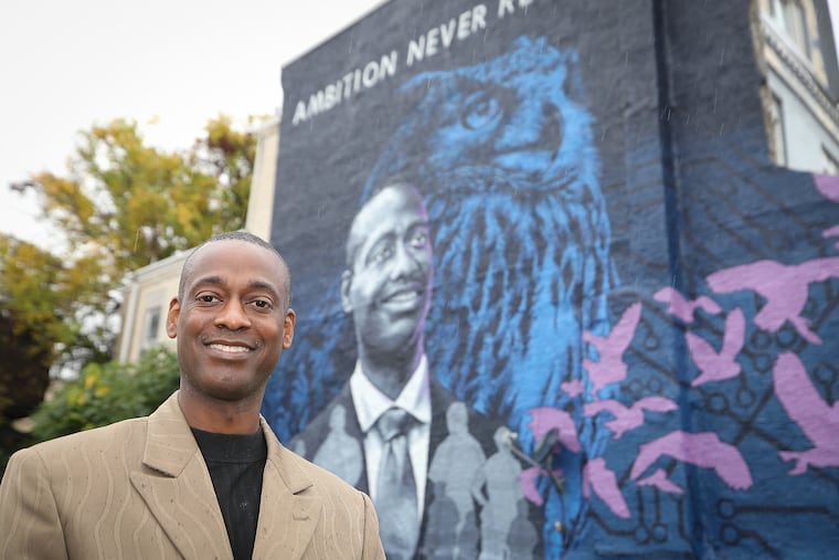 Rev. Shayne E. Moore in front of a mural he inspired at the corner of Wayne Avenue and Berkley Street in Philadelphia. An IT professional. Rev. Moore is a graduate of Western Governors University, which is erecting murals nationwide to honor contributions of alums. The mural was created by Philadelphia artist Erik Okdeh.
