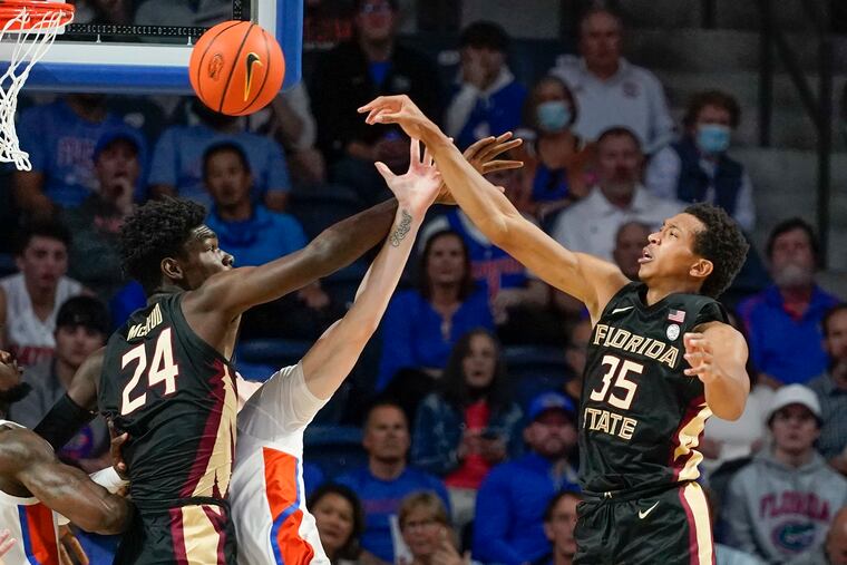 Florida State's Naheem McLeod (24) guarding Florida forward Colin Castleton on Nov. 14, 2021.
