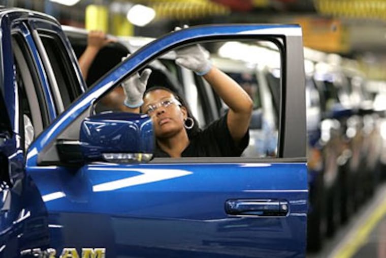 Yolanda Germany checks the door molding on Chrysler's new 2009 Dodge Ram pickup being assembled at the Warren Truck Plant in Warren, Mich. (AP Photo/Carlos Osorio)