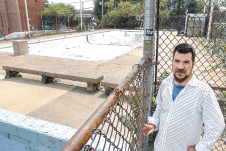 With three nearby public pools closed, Fishtown resident Andrew Christman has been finding other entertainment for his son. “We’re the only area where there’s no safe walking distance to the pools,” he said. (Akira Suwa / Staff Photographer)