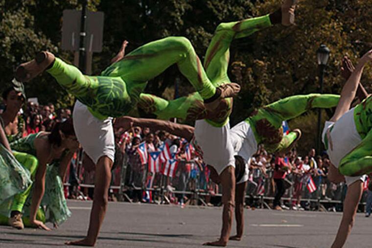 Performers from Esperanza Academy Charter School wear rain-forest-themed costumes to promote awareness of Puerto Rico's El Yunque National Rain Forest. (Patrick McPeak/Staff)