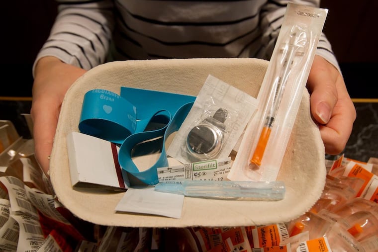 Registered nurse Sammy Mullally holds a tray of supplies to be used by a drug addict at the Insite safe injection clinic in Vancouver, B.C.,