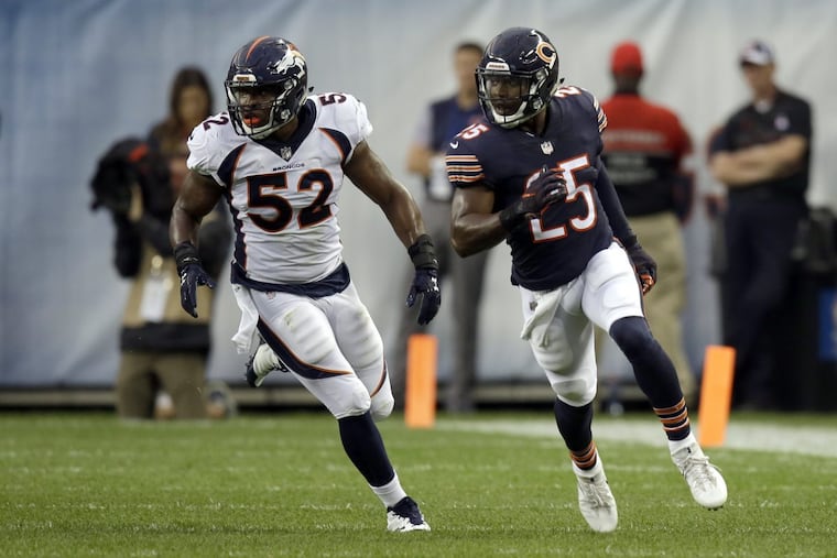 Corey Nelson (52) defending Bears running back Ka'Deem Carey (25) during a preseason game last year..